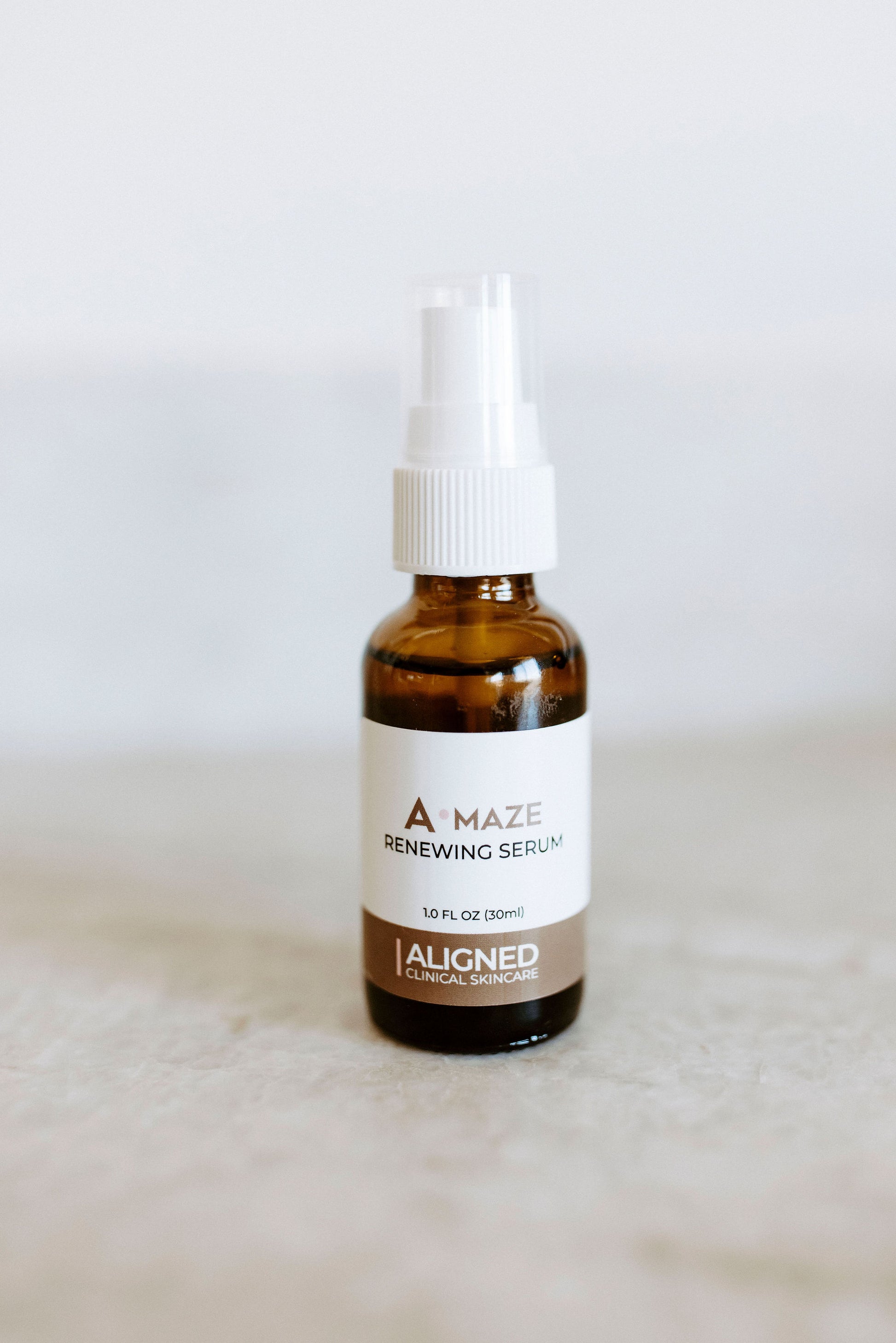 A-maze Renewing Serum in amber glass pump bottle
