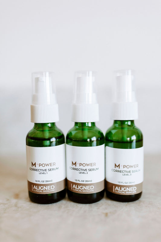 Three bottles of MPower Corrective Serum in green glass dropper bottles